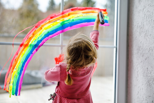 girl drawing a rainbow