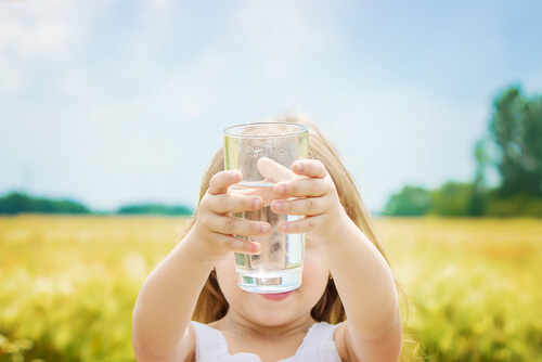 girl holding a glass of water